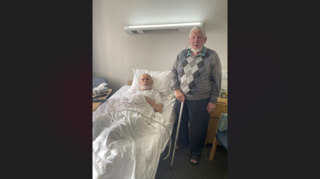 A volunteer visiting an elderly resident in an aged care facility